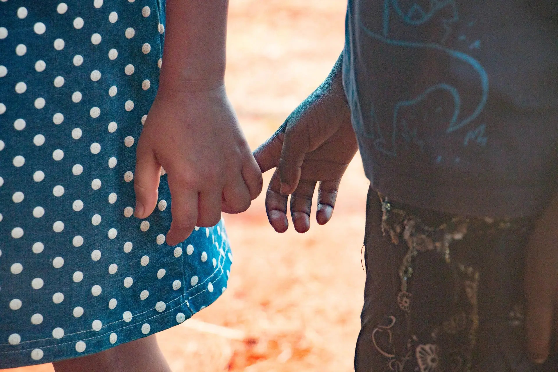Stronger together – building trust and unity Two children holding hands, symbolizing community and connection in rural Zambia